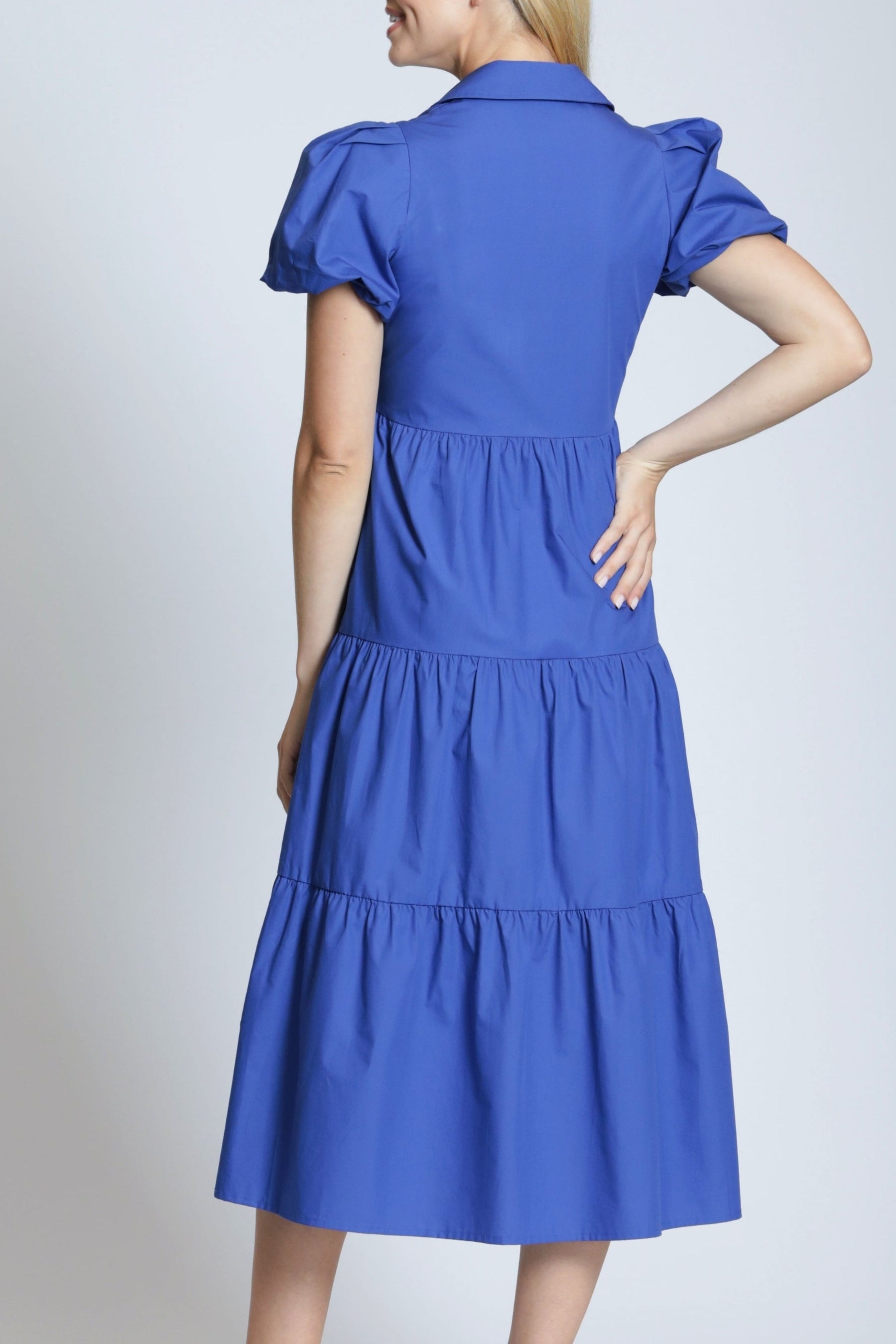 Woman wearing a blue dress on a white background