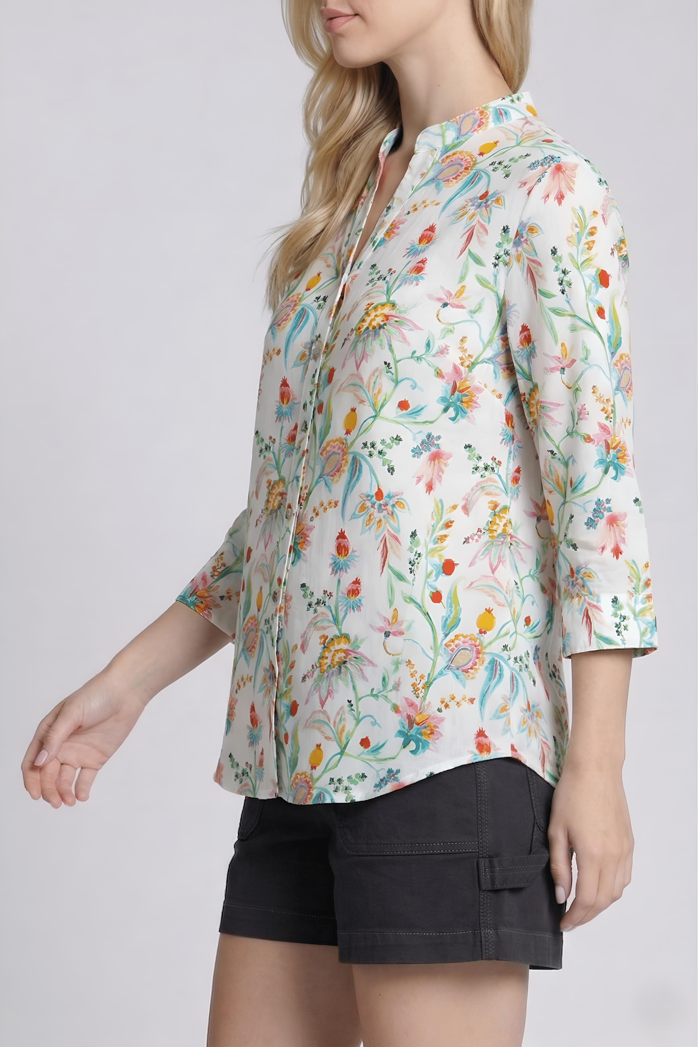 Woman wearing a floral blouse with a plain background