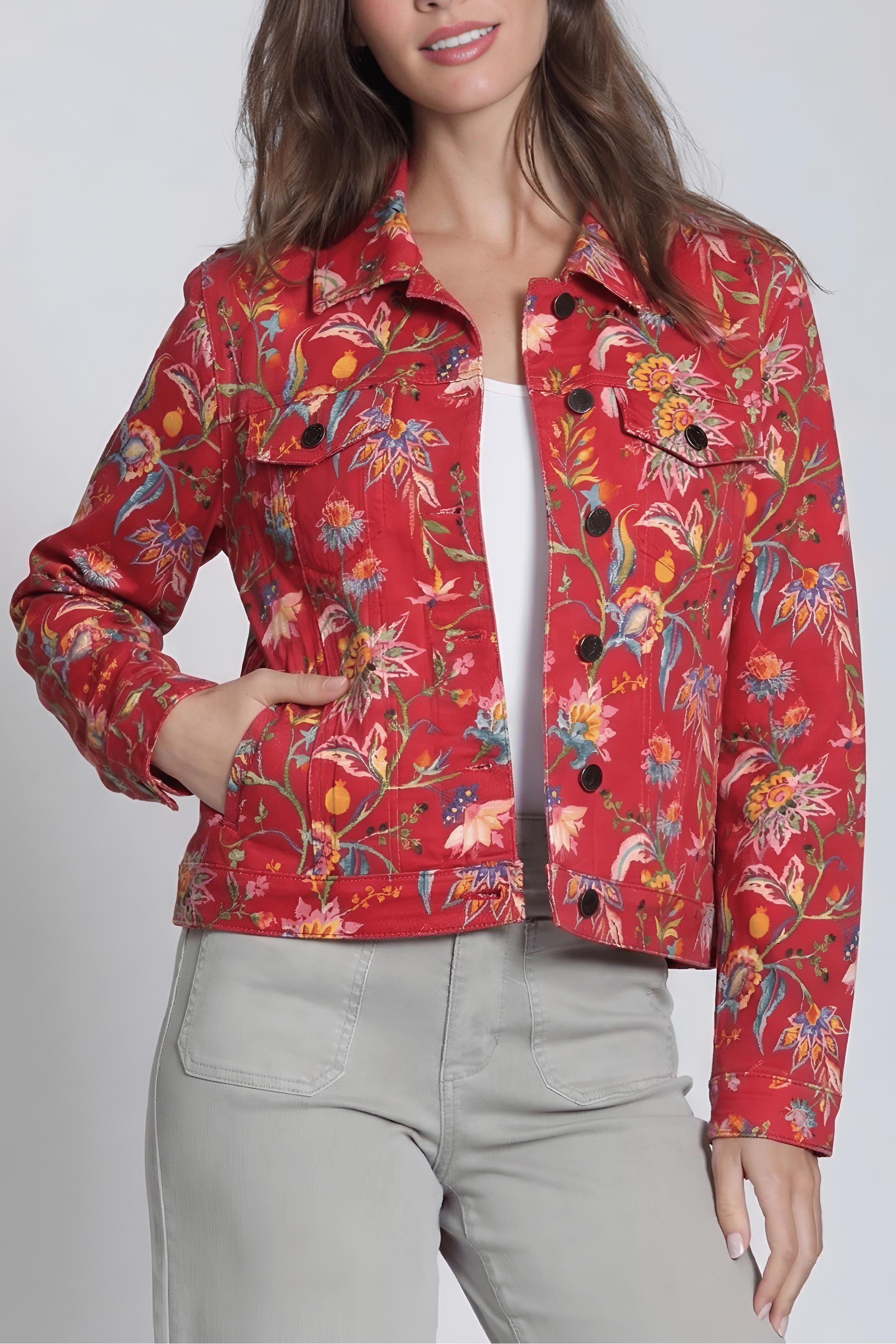 Woman wearing a red floral jacket against a white background