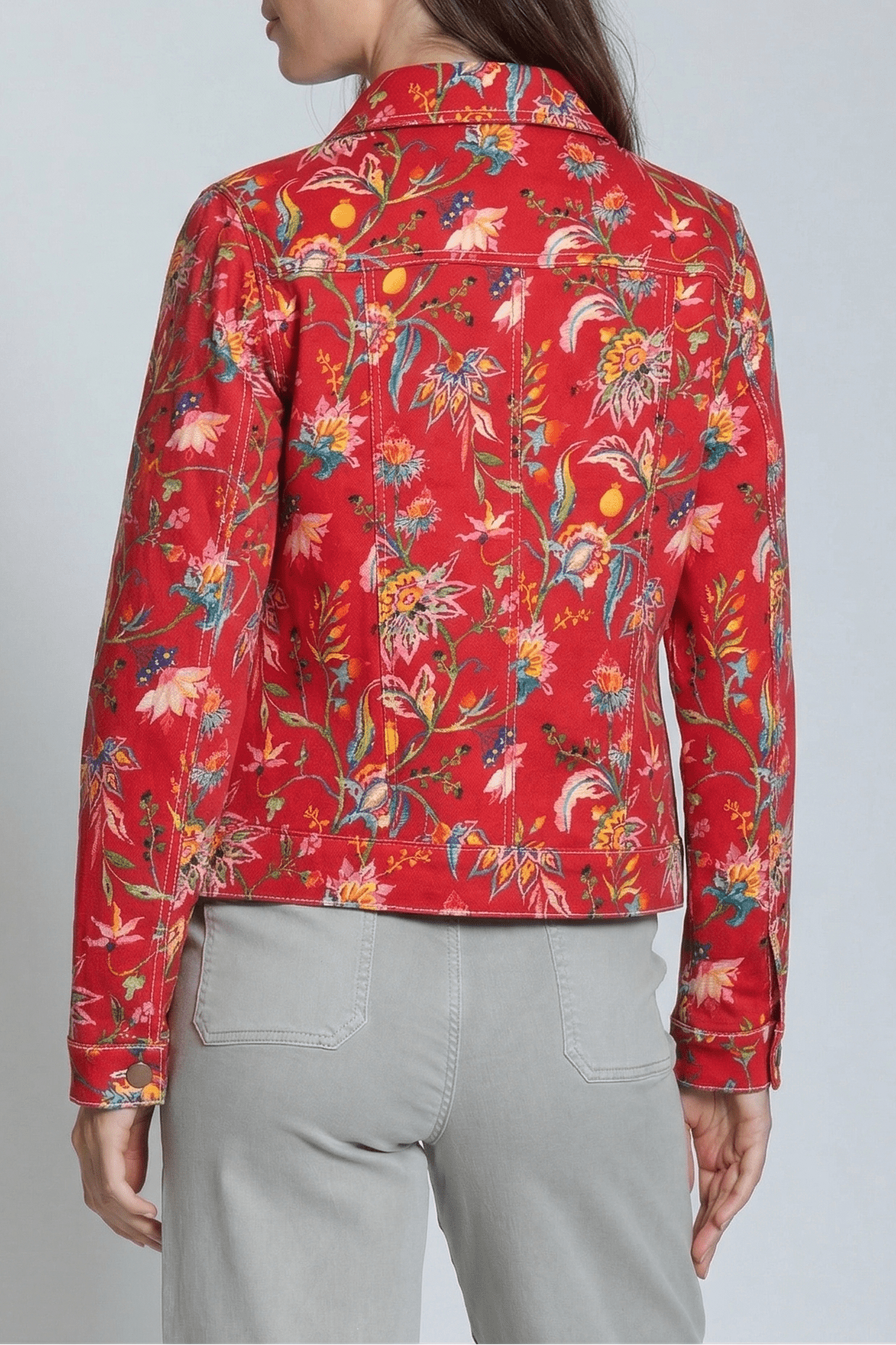 Red floral patterned shirt worn by a person on a plain background