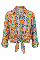 Colorful floral patterned blouse with a tie front on a white background