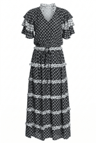 Black and white patterned dress with ruffled sleeves on a white background