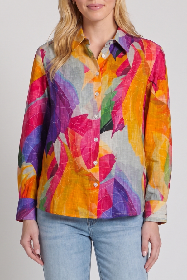 Person wearing a colorful patterned shirt with a plain background