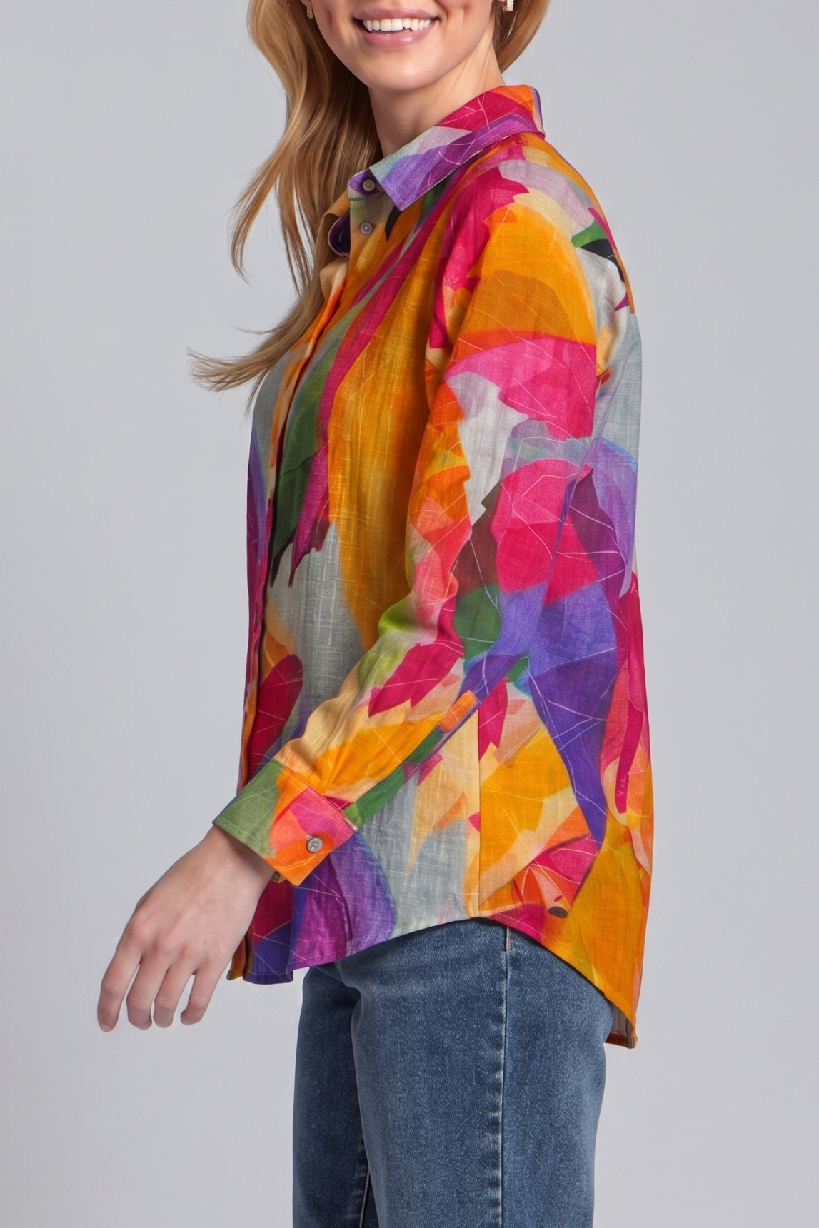 Woman wearing a colorful patterned shirt against a gray background