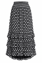Black and white polka dot skirt with ruffled layers on a white background